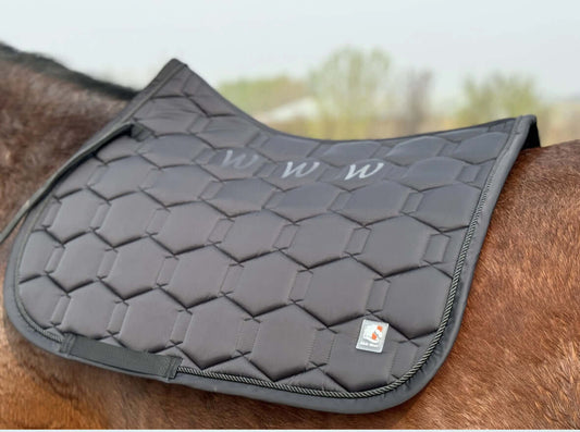 Mantilla para caballo premium en color negro con diseño acolchado y logotipo, ideal para estilo y confort ecuestre.
